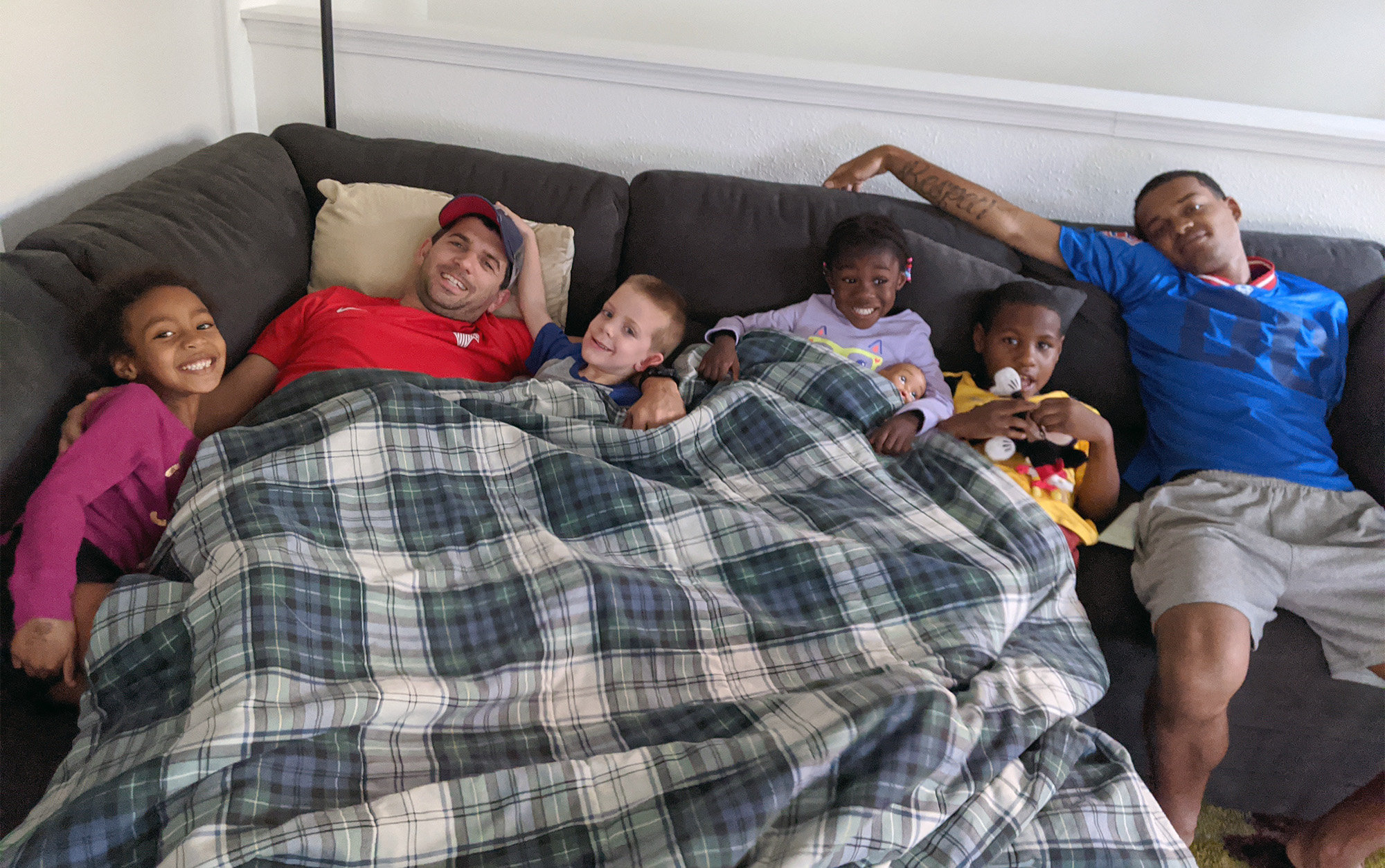 Amico family photo cuddling in bed