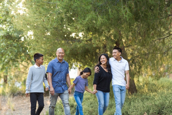 Happy family walking in park