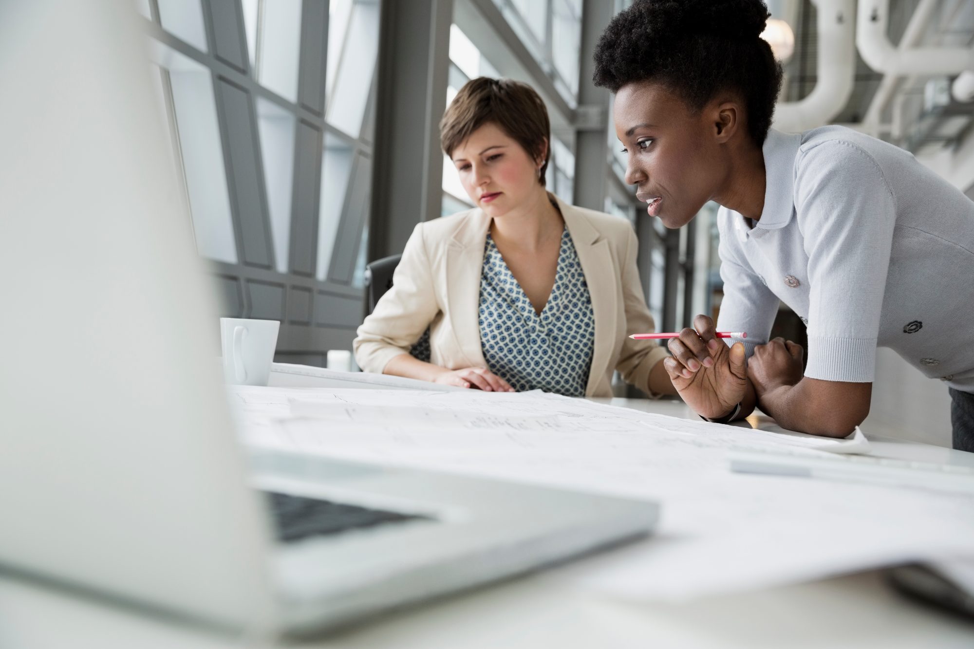 Businesswomen looking at documents in office