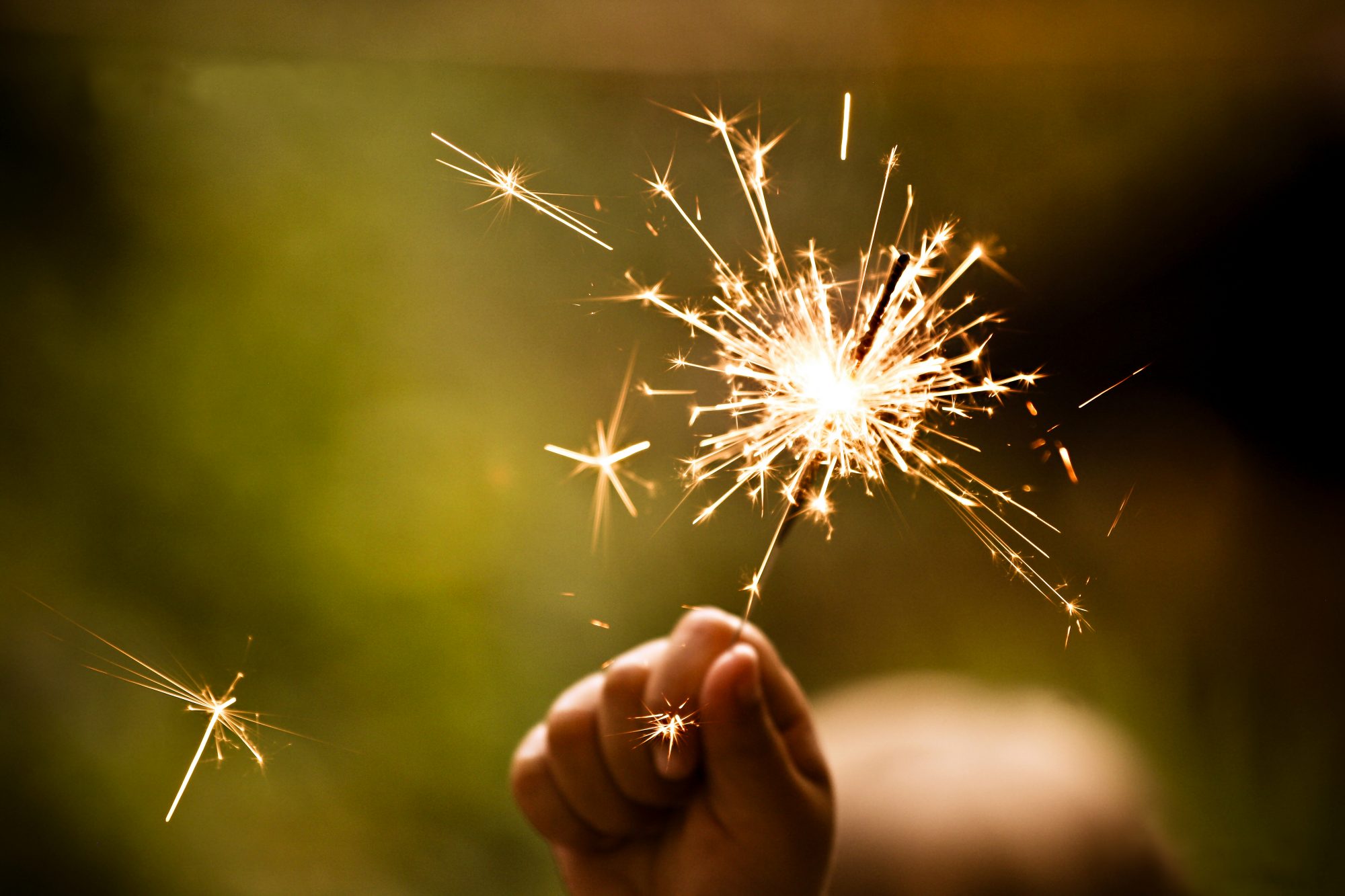 Sparkler in hand to represent supercharging your giving
