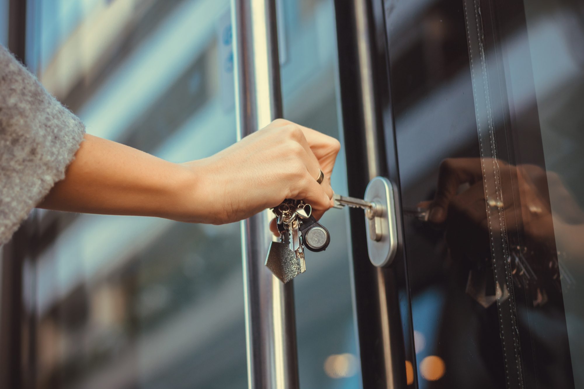 Woman putting keys in to unlock the door