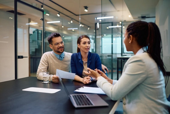 couple talking to financial advisor about donating stock 