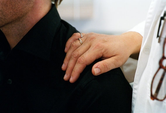 doctor with hand on patient shoulder