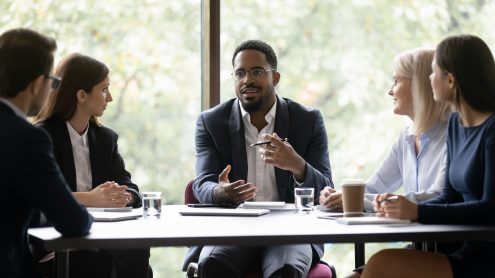 Engaged coworkers sitting at a table discussing work