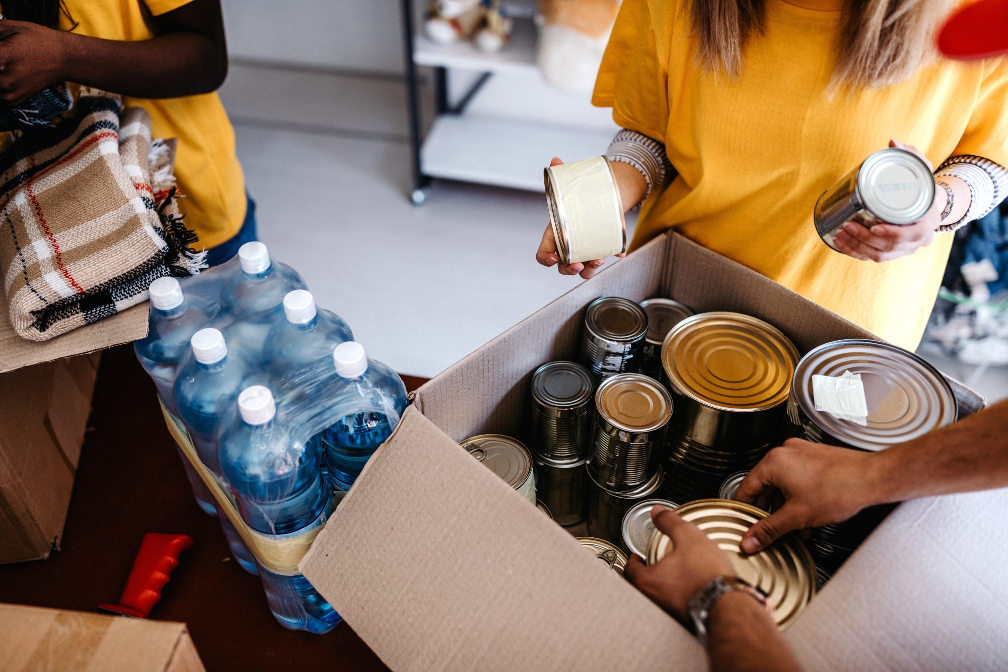 People packing canned food into boxes