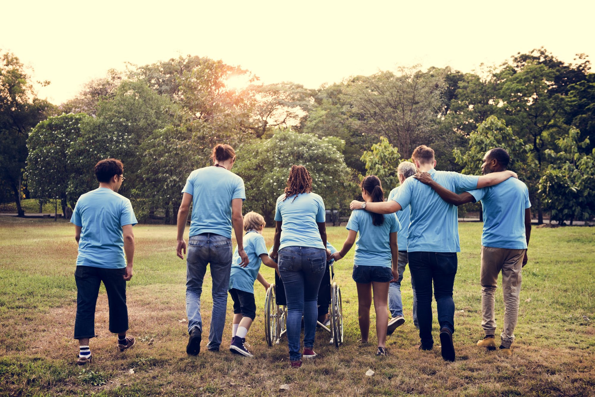 Group of diverse volunteers walking together in park