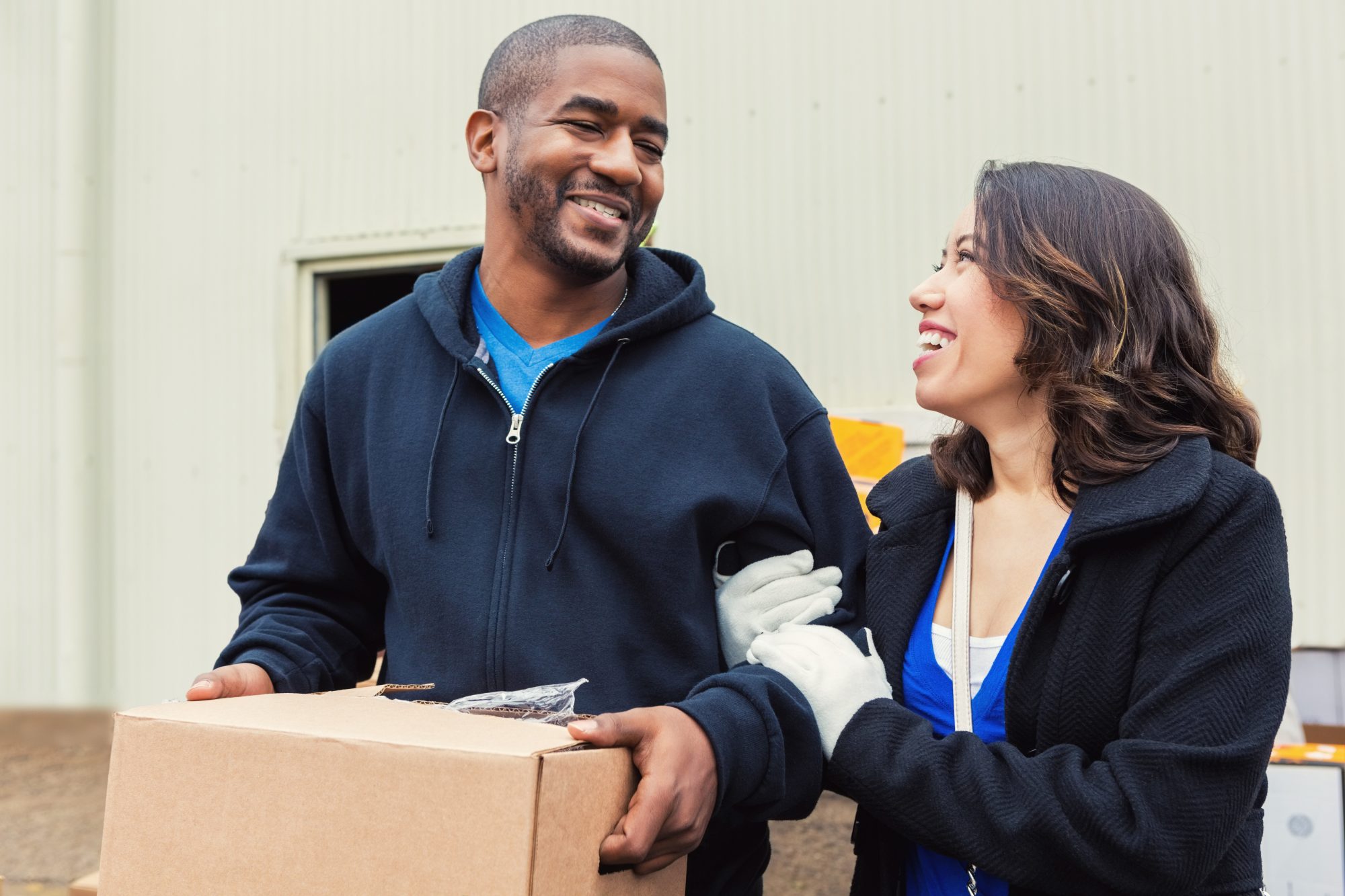 Couple donating box of goods