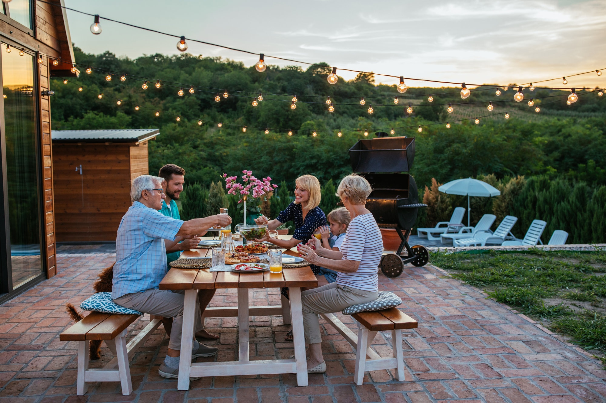 Multi-generational family having dinner outside on a patio