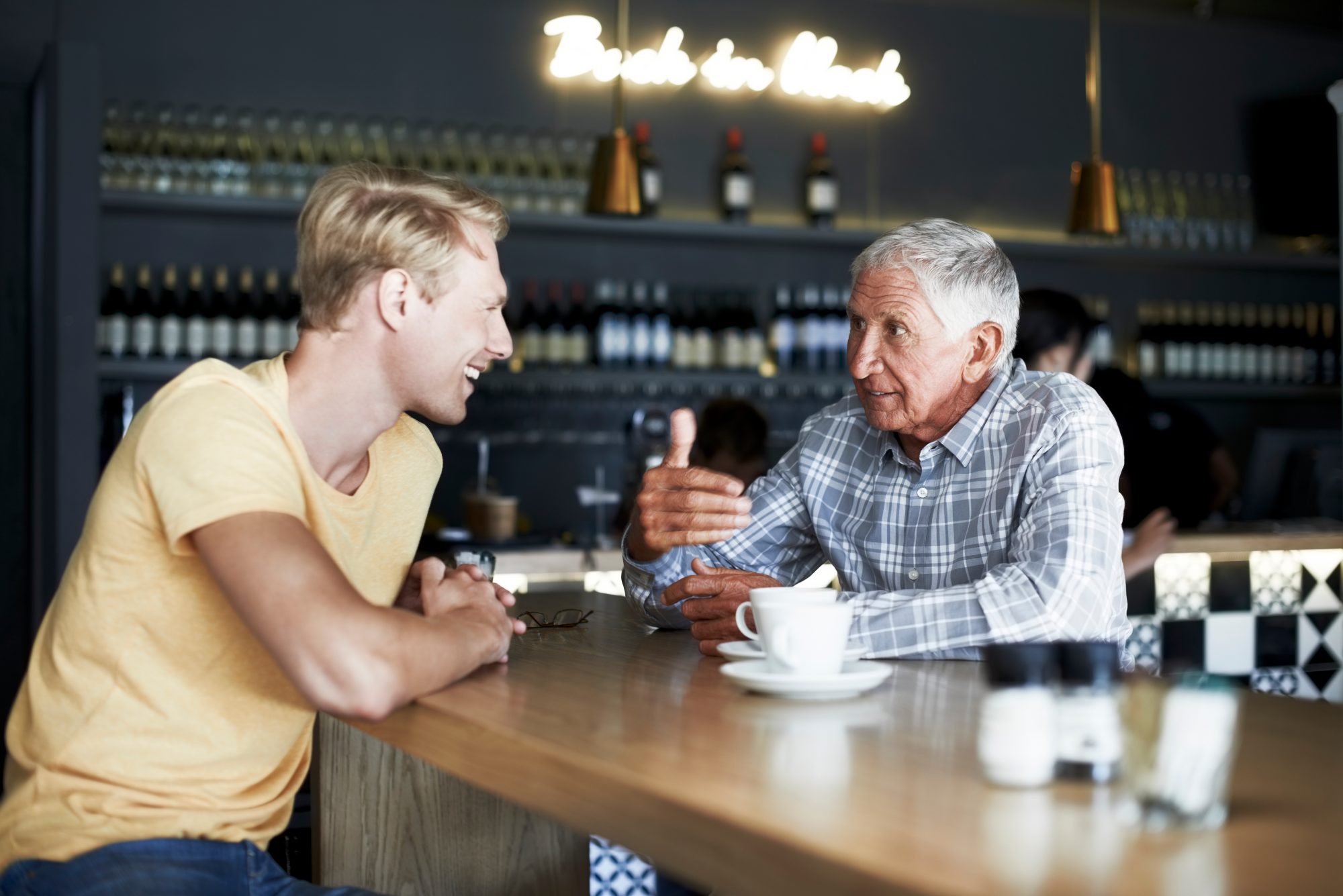 A grandpa and grandson having a conversation about charitable giving to represent inspiring the next generation of philanthropists.