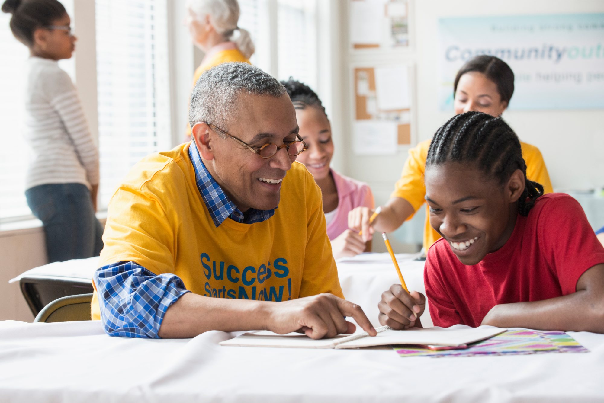 Photo of a man volunteering with a teenager to represent board effectiveness.