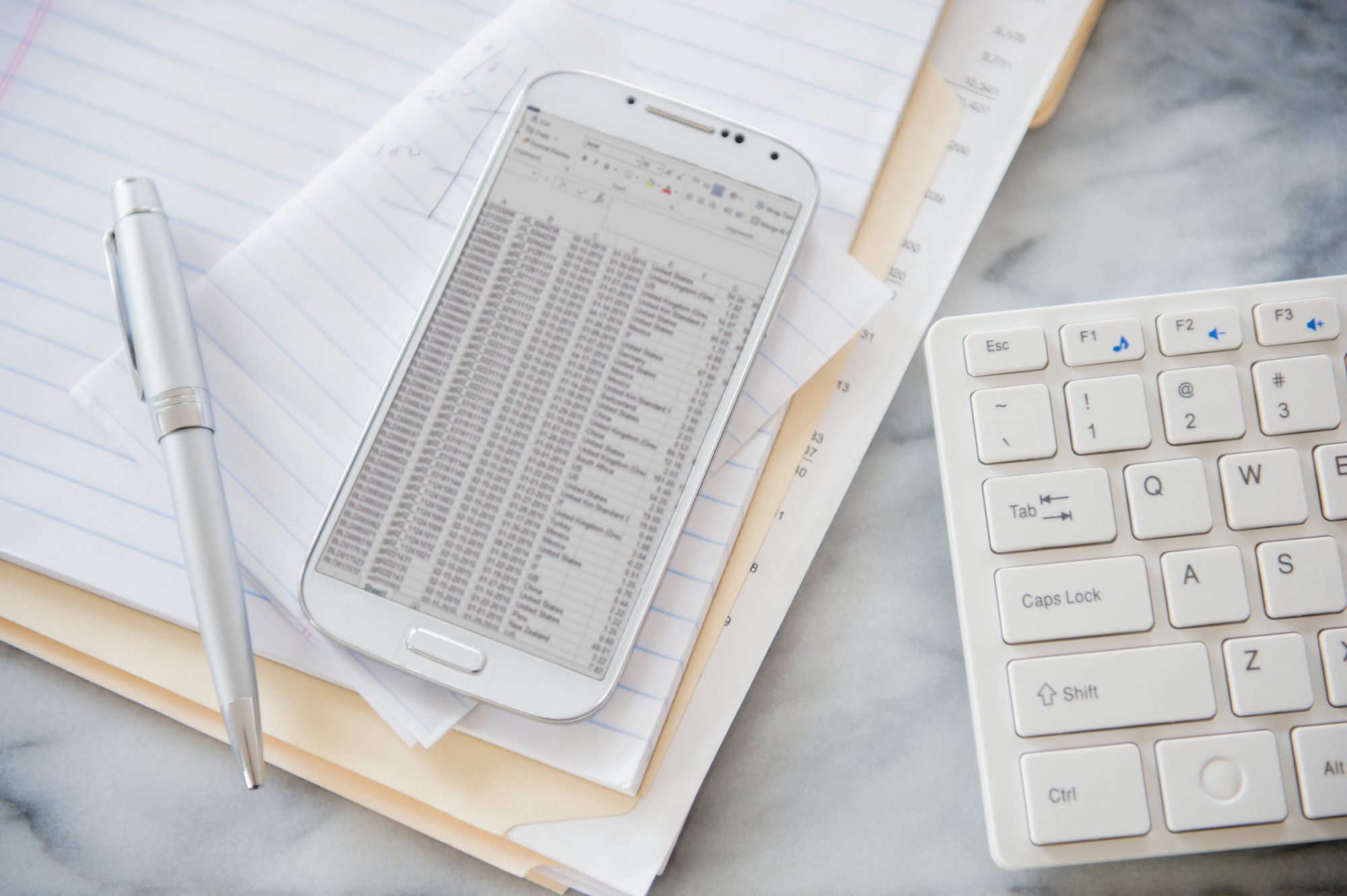 Image of white paper, pen and keyboard