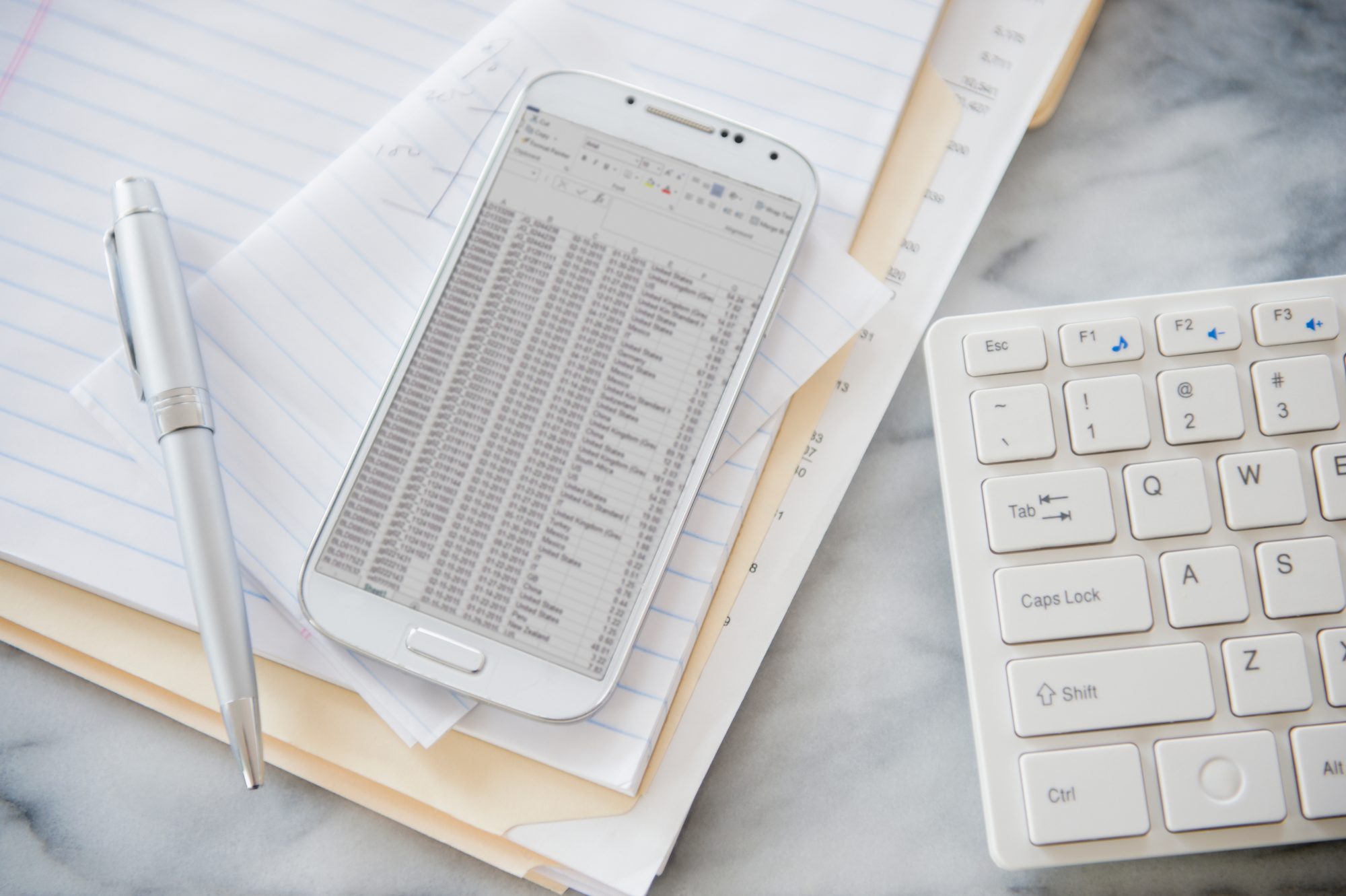 Image of white paper, pen and keyboard