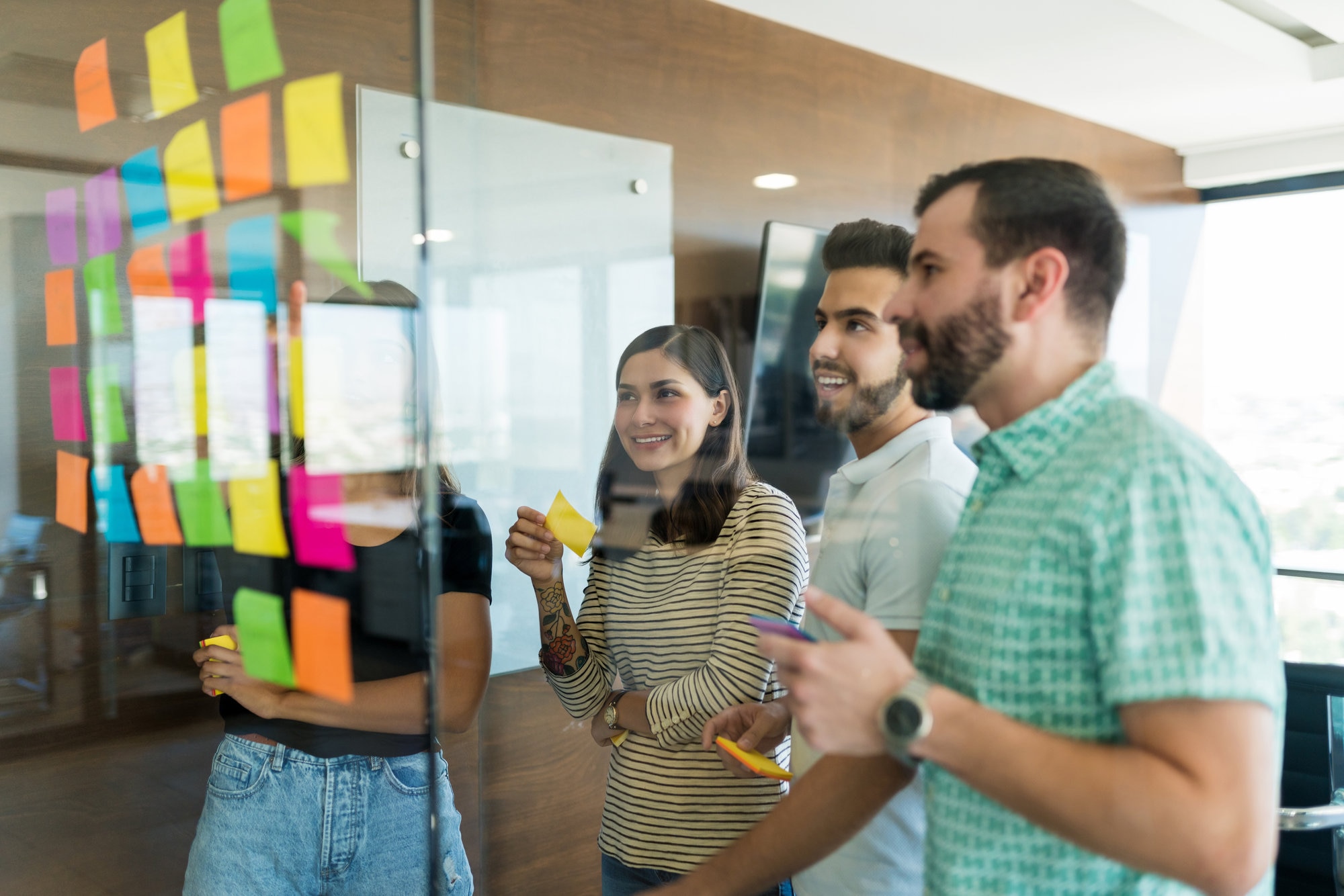 A group of people using sticky notes to solve a complex problem that AI could navigate much quicker.
