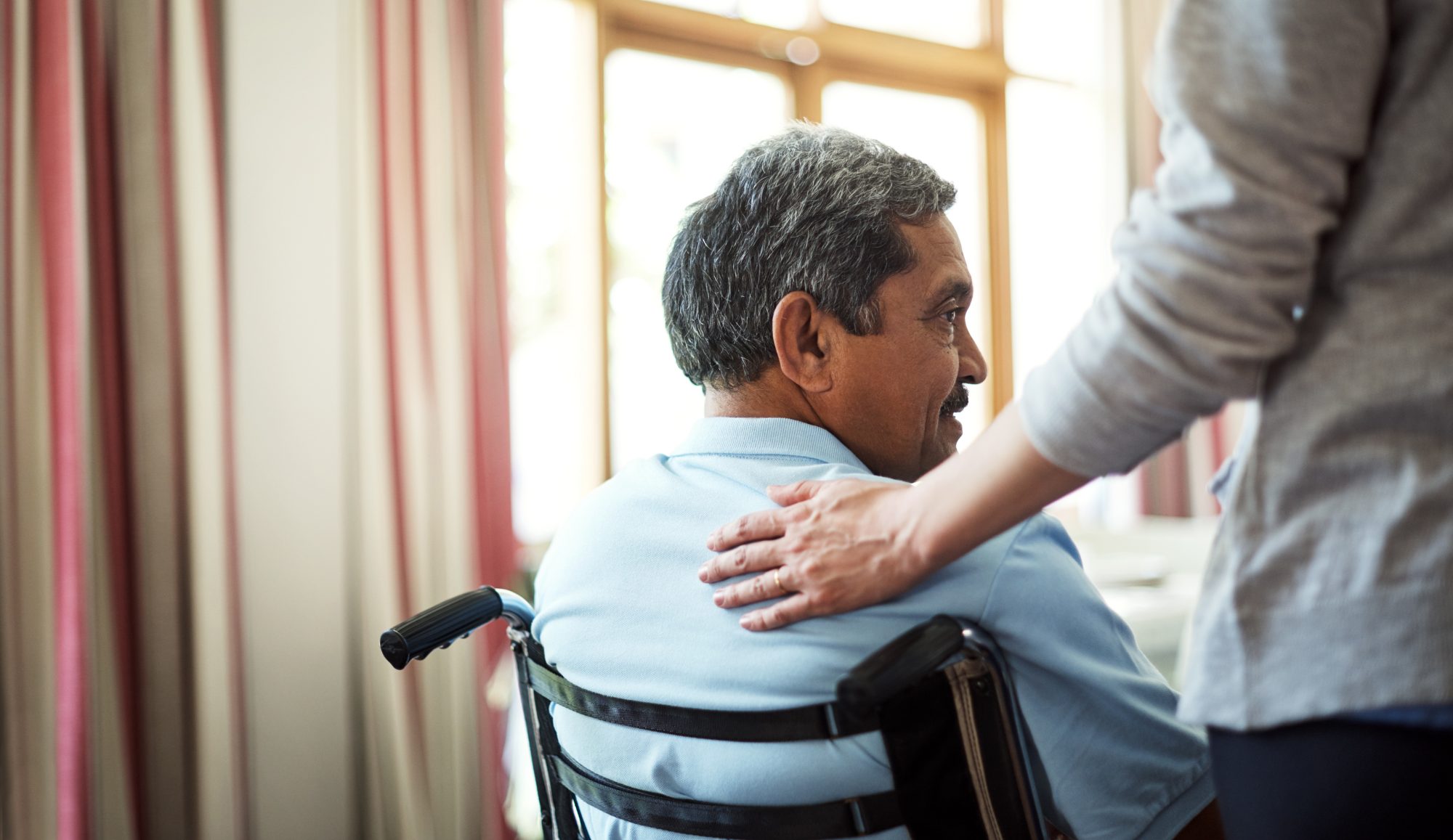 Nurse caring for a senior man in a retirement home
