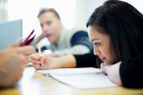 Young college woman taking notes