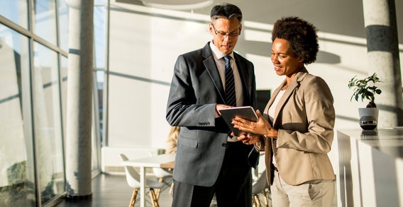 couple talking to financial advisor about donating stock 