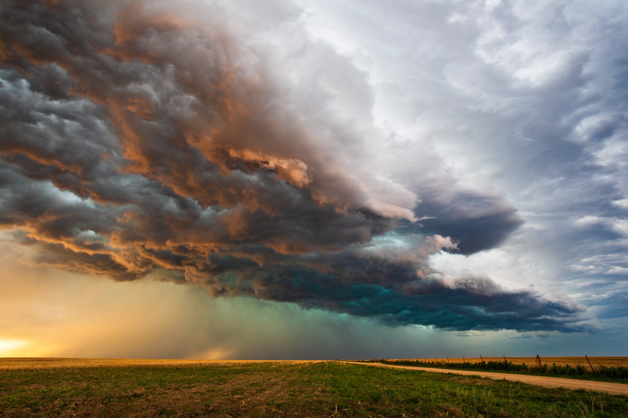 Sunset and storm clouds over a field