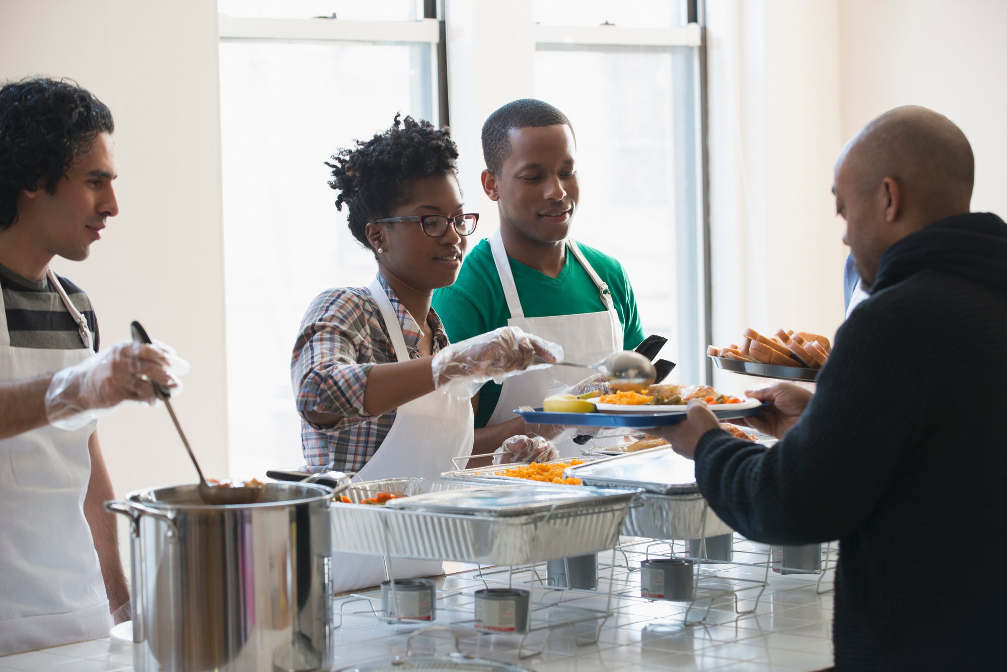 Volunteers serving food in cafeteria