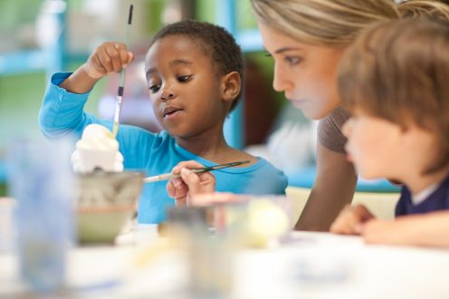 Children and teacher painting