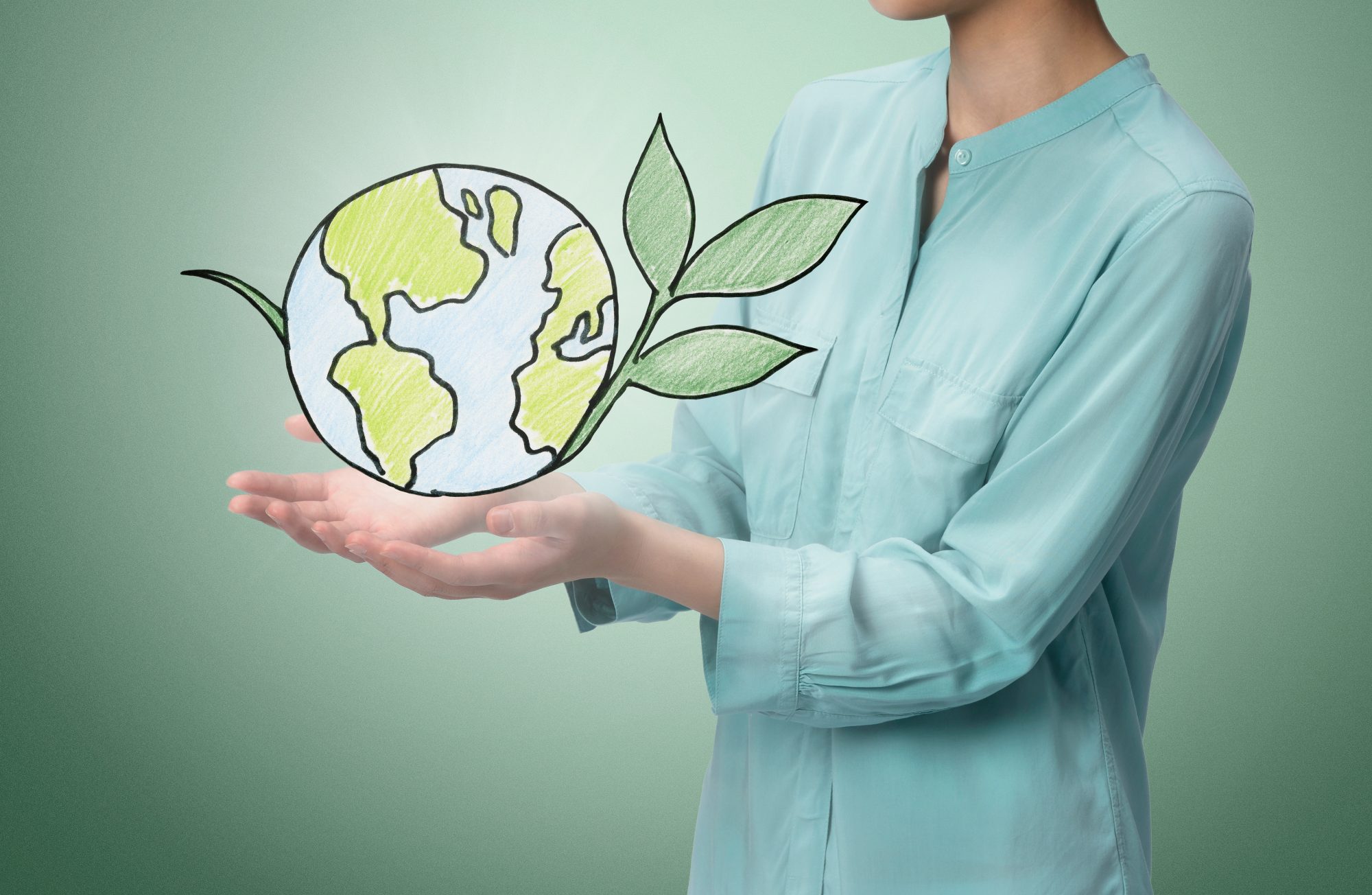 Woman holding illustration of the world to represent impact investing.