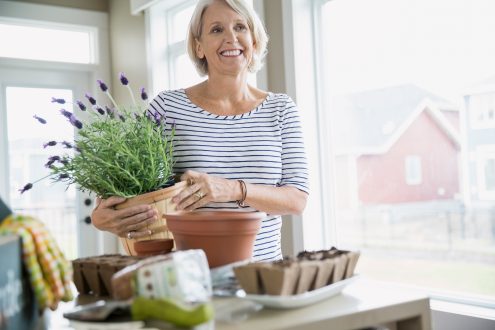 A happy Baby Boomer woman with flowers