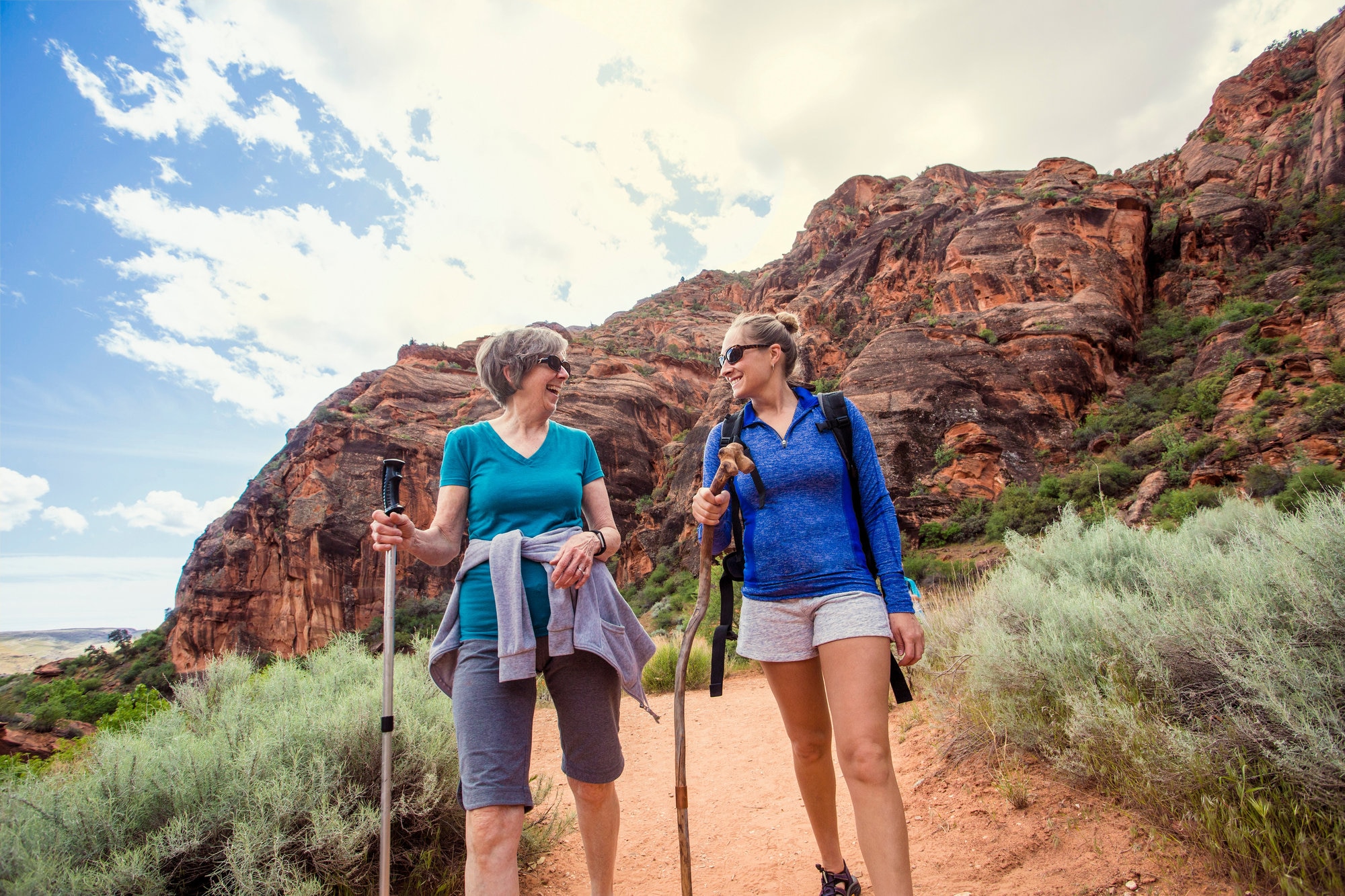 Two women hiking together at red rock canyon