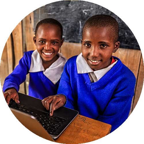 Two children smiling at the camera represent giving to the International Affairs sector.