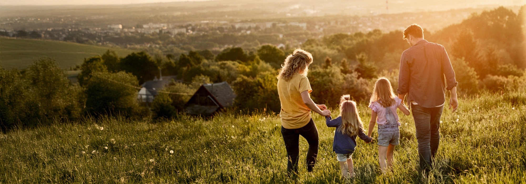 Family walking on a hilltop