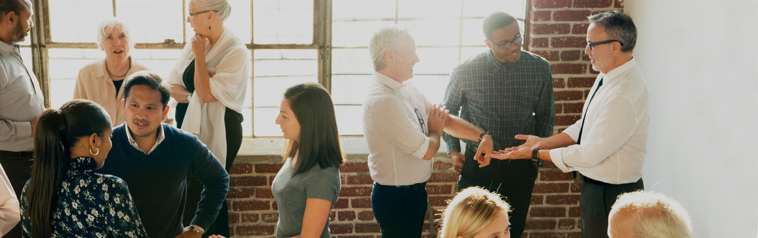 People engaging in conversation at event