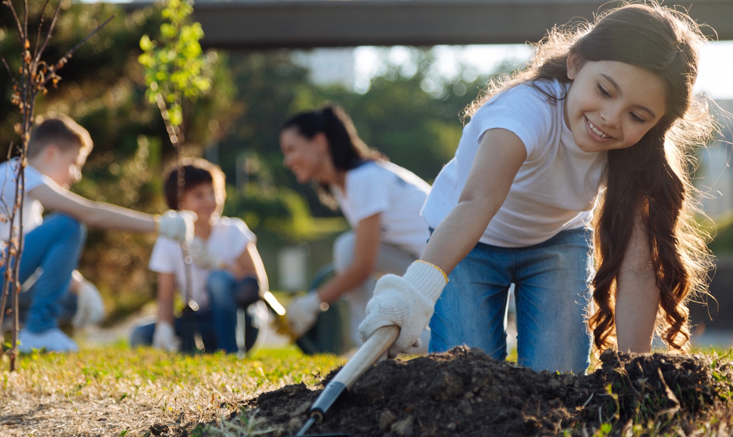 Girl digging in community garden.