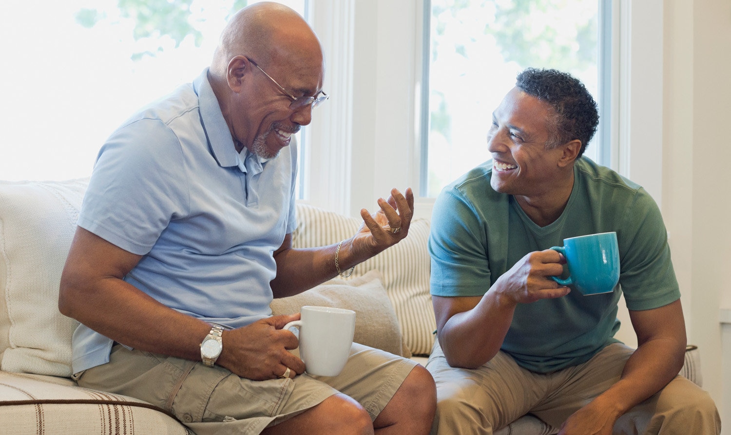 Man and adult son laughing.