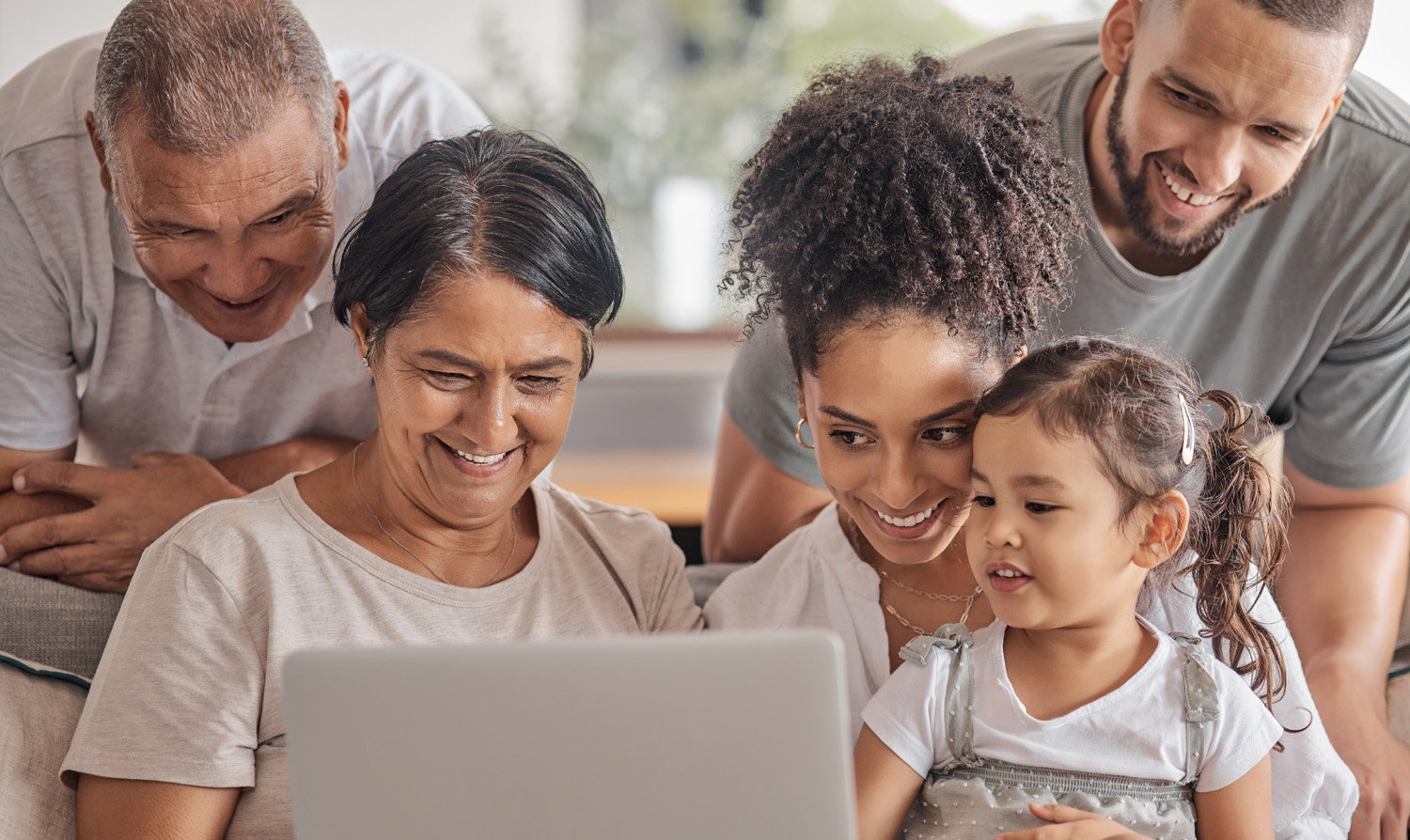 Parents and children looking at a laptop and considering online giving choices.