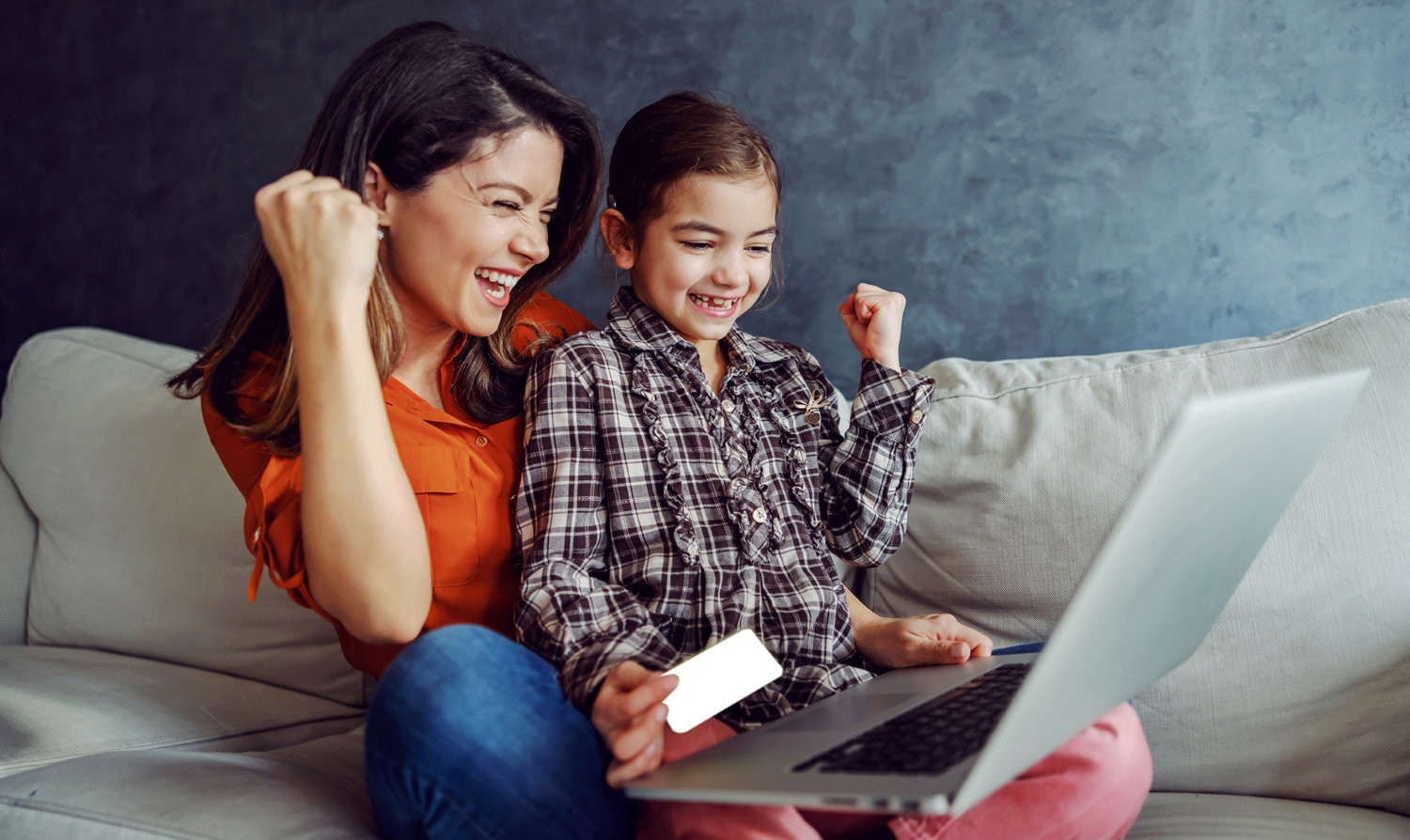 Woman and child celebrating donating money online.
